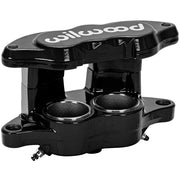 Wilwood black brake caliper in an open-side angled view, showing two circular recesses, mounting holes and white bridge lettering