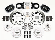 Wilwood Ford and Mercury spindle front parts layout with black Dynapro dust-boot calipers, 12.19-inch drilled-and-slotted rotors, separate hubs, bearings, pads and mounting brackets