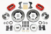 Wilwood ProSpindle front parts layout with red Dynapro dust-boot calipers, 11-inch drilled-and-slotted rotors, separate hubs, bearings, pads and mounting brackets