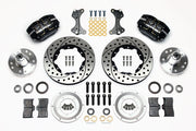 Wilwood ProSpindle front parts layout with black Dynapro dust-boot calipers, 11-inch drilled-and-slotted rotors, separate hubs, bearings, pads and mounting brackets