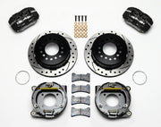 Wilwood BOP rear Dynapro Low-Profile parking-brake kit laid out with black calipers, drilled and slotted rotors, internal parking-shoe assemblies and mounting parts