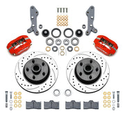 Wilwood full-size front Dynalite-M brake kit laid out with red calipers, drilled and slotted rotor/hubs, bearings, pads and mounting hardware