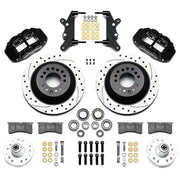 Wilwood full-size front Superlite rotor-hat brake kit laid out with black calipers, drilled and slotted one-piece rotor/hats, separate hubs, pads and brackets