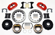 Wilwood staggered Big Ford New Style rear brake kit laid out with red calipers, drilled and slotted rotors, internal parking-shoe assemblies and mounting parts