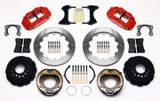 Wilwood staggered Big Ford New Style rear brake kit laid out with red calipers, slotted rotors, internal parking-shoe assemblies and mounting parts