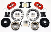 Wilwood staggered GM 12-bolt rear brake kit laid out with red calipers, drilled and slotted rotors, internal parking-shoe assemblies and mounting parts