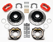 Wilwood Ford 8.8 Special rear Dynalite brake kit laid out with red calipers, drilled and slotted rotors, internal parking-shoe assemblies and mounting parts