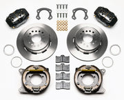 Wilwood Ford 8.8 Special rear Dynalite brake kit laid out with black calipers, plain-face rotors, internal parking-shoe assemblies and mounting parts
