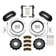 Wilwood six-lug Ford/Lincoln front TX6R brake kit laid out with black calipers, slotted rotors and hats, pads and mounting brackets, with hoses
