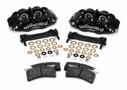 Wilwood black rear Superlite caliper kit laid out with mounting brackets, shims, fasteners and brake pads