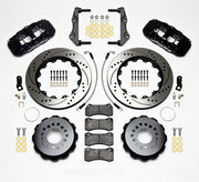 Wilwood black AERO4 kit laid out with drilled-and-slotted rotor rings, separate hats, brake pads, brackets, braided hoses and hardware