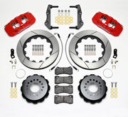 Wilwood red AERO4 kit laid out with slotted rotor rings, separate hats, brake pads, brackets, braided hoses and hardware