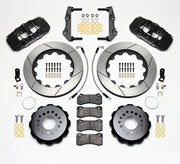 Wilwood black AERO4 kit laid out with slotted rotor rings, separate hats, brake pads, brackets, braided hoses and hardware