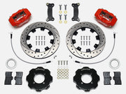 Wilwood red Dynalite kit laid out with drilled-and-slotted rotor rings, separate hats, brake pads, brackets, braided hoses and hardware