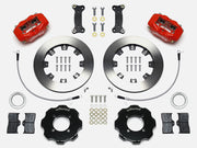 Wilwood red Dynalite kit laid out with plain-face rotor rings, separate hats, brake pads, brackets, braided hoses and hardware