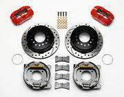 Wilwood Dynapro Low-Profile brake kit: Two red calipers with dark drilled-and-slotted rotor/hat assemblies, exposed parking-shoe backing assemblies, pads and mounting hardware; 11-inch rear brake setup for 12-Bolt C-Clip.