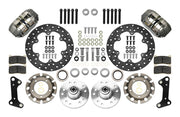 Wilwood Dynapro brake kit: Two gray anodized Dynapro calipers, thin drilled rotors, round rotor adapters, aluminum hubs, bearings, pads, spindle brackets and fasteners arranged as a parts layout; 10.75-inch front brake setup for GM/RideTech Pin Spindle.