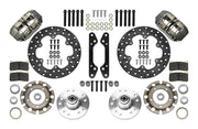Wilwood Dynapro brake kit: Two gray anodized Dynapro calipers, thin drilled rotors, round rotor adapters, aluminum hubs, bearings, pads, spindle brackets and fasteners arranged as a parts layout; 10.75-inch front brake setup for GM 11 in OE Disc Spindle.
