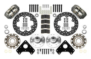 Wilwood Dynapro brake kit: Two gray anodized Dynapro calipers, thin drilled rotors, round rotor adapters, aluminum hubs, bearings, pads, spindle brackets and fasteners arranged as a parts layout; 10.75-inch front brake setup for GM/Isuzu RWD.