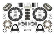 Wilwood Dynapro brake kit: Two gray anodized Dynapro calipers, thin drilled rotors, round rotor adapters, aluminum hubs, bearings, pads, spindle brackets and fasteners arranged as a parts layout; 10.75-inch front brake setup for Mustang/Thunderbird.