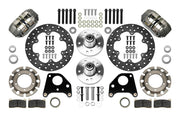 Wilwood Dynapro brake kit: Two gray anodized Dynapro calipers, thin drilled rotors, round rotor adapters, aluminum hubs, bearings, pads, spindle brackets and fasteners arranged as a parts layout; 10.75-inch front brake setup for Dodge/Plymouth B/E.