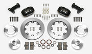 Wilwood Dynalite brake kit: Two black calipers, plain rotor rings, separate aluminum adapters and hubs, bearings, pads, spindle brackets and fasteners arranged as a kit layout; 12.19-inch front brake setup for Mustang II/Pinto/Bobcat.