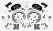 Wilwood Dynapro 6 brake kit: Two black calipers, plain rotor rings, separate aluminum adapters and hubs, bearings, pads, spindle brackets and fasteners arranged as a kit layout; 12.19-inch front brake setup for Pinto/Bobcat/Mustang II.