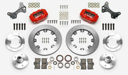 Wilwood Dynalite brake kit: Two red calipers, plain rotor rings, separate aluminum adapters and hubs, bearings, pads, spindle brackets and fasteners arranged as a kit layout; 12.19-inch front brake setup for ProSpindle 5 x 5.