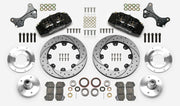 Wilwood Dynapro 6 brake kit: Two black calipers, drilled-and-slotted rotor rings, separate aluminum adapters and hubs, bearings, pads, spindle brackets and fasteners arranged as a kit layout; 12.19-inch front brake setup for ProSpindle 5 x 5.