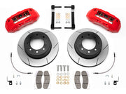 Wilwood TX6R brake kit: Pair of red TX6R calipers, slotted rotors with integral black hats, pads, braided hoses, brackets and fasteners laid out; 15.5-inch rear brake setup for Super Duty 4WD SRW.