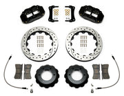 Wilwood Superlite 6R brake kit: Two black Superlite calipers, drilled-and-slotted rotors, separate deep black hats, pads, curved braided hoses, fittings, brackets and fasteners laid out; 12.88-inch front brake setup for Toyota/Lexus Six-Lug.