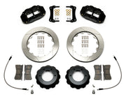 Wilwood Superlite 6R brake kit: Two black Superlite calipers, slotted rotors, separate deep black hats, pads, curved braided hoses, fittings, brackets and fasteners laid out; 12.88-inch front brake setup for Toyota/Lexus Six-Lug.