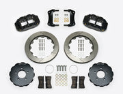 Wilwood Superlite 6R brake kit: Two black calipers, slotted rotor rings, separate dark hats, pads, brackets, centering rings and fasteners laid out; no hoses visible; 12.88-inch front brake setup for Ford Panther Cars.