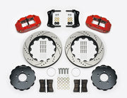 Wilwood Superlite 6R brake kit: Two red calipers, drilled-and-slotted rotor rings, separate dark hats, pads, brackets, centering rings and fasteners laid out; no hoses visible; 14-inch front brake setup for Ford Panther Cars.