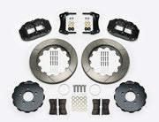 Wilwood Superlite 6R brake kit: Two black calipers, slotted rotor rings, separate dark hats, pads, brackets, centering rings and fasteners laid out; no hoses visible; 14-inch front brake setup for Ford Panther Cars.