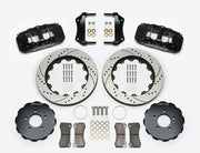 Wilwood AERO6 brake kit: Two black calipers, drilled-and-slotted rotor rings, separate dark hats, pads, brackets, centering rings and fasteners laid out; no hoses visible; 14-inch front brake setup for Ford Panther Cars.