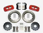 Wilwood AERO6 brake kit: Two red calipers, slotted rotor rings, separate dark hats, pads, brackets, centering rings and fasteners laid out; no hoses visible; 14-inch front brake setup for Ford Panther Cars.
