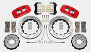Wilwood AERO6 brake kit: Pair of red calipers, drilled-and-slotted rotor rings, hats with their inner faces visible, pads, hoses, brackets and mounting fasteners arranged on white; 14-inch front brake setup for BMW E46 M3.