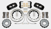 Wilwood AERO6 brake kit: Pair of black calipers, drilled-and-slotted rotor rings, hats with their inner faces visible, pads, hoses, brackets and mounting fasteners arranged on white; 14-inch front brake setup for BMW E46 M3.