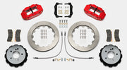 Wilwood Superlite 4R brake kit: Pair of red calipers, slotted rotor rings, hats with their inner faces visible, pads, hoses, brackets and mounting fasteners arranged on white; 12.88-inch rear brake setup for BMW E46 M3.