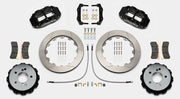 Wilwood Superlite 4R brake kit: Pair of black calipers, slotted rotor rings, hats with their inner faces visible, pads, hoses, brackets and mounting fasteners arranged on white; 12.88-inch rear brake setup for BMW E46 M3.