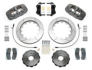 Wilwood AERO6-ST brake kit: Pair of gray anodized AERO6 calipers, slotted rotors, separate dark hats, pads, braided hoses, brackets and fasteners arranged as a parts layout; 14-inch front brake setup for 350Z/G35.