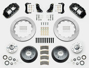 Wilwood Superlite 6R brake kit: Two black calipers, slotted rotor rings, deep dark hats, separate aluminum hubs, bearings, pads, mounting brackets, wheel studs and fasteners in a layout; 12.88-inch front brake setup for 1957–1967 F-100.