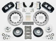 Wilwood AERO6 brake kit: Two black calipers, drilled-and-slotted rotor rings, deep dark hats, separate aluminum hubs, bearings, pads, mounting brackets, wheel studs and fasteners in a layout; 14-inch front brake setup for 1957–1967 F-100.