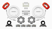 Wilwood Dynalite front brake kit, TR4A / TR250 / TR6, 11-inch plain rotors: Parts layout with two red Dynalite calipers, plain face rotor rings, separate black hats, pads, brackets and fasteners, with curved flexlines visible.