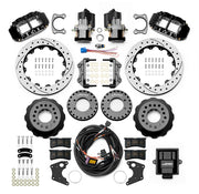 Wilwood Big Ford 2.36-inch-offset axle rear kit laid out with black Superlite 4R service calipers, separate electric parking calipers, 12.88-inch drilled-and-slotted rotors, brackets, pads, wiring harness and controller
