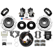 Wilwood 12 Bolt 2.75-inch-offset axle rear kit laid out with black Dynalite service calipers, separate electric parking calipers, 12.19-inch drilled-and-slotted rotors, brackets, pads, wiring harness and controller
