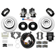 Wilwood 12 Bolt 2.75-inch-offset axle rear kit laid out with black Dynalite service calipers, separate electric parking calipers, 12.19-inch plain-face rotors, brackets, pads, wiring harness and controller