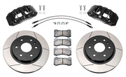 Wilwood front AERODM brake kit for later GM 1500 trucks/SUVs: Two black AERODM calipers with slotted one-piece rotors, brake pads and mounting fasteners, braided hoses and fittings laid out.