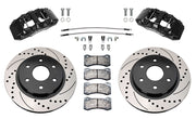 Wilwood front AERODM brake kit for Ford F-150/Expedition and Lincoln Navigator: Two black AERODM calipers with drilled and slotted one-piece rotors, brake pads and mounting fasteners, braided hoses and fittings laid out.